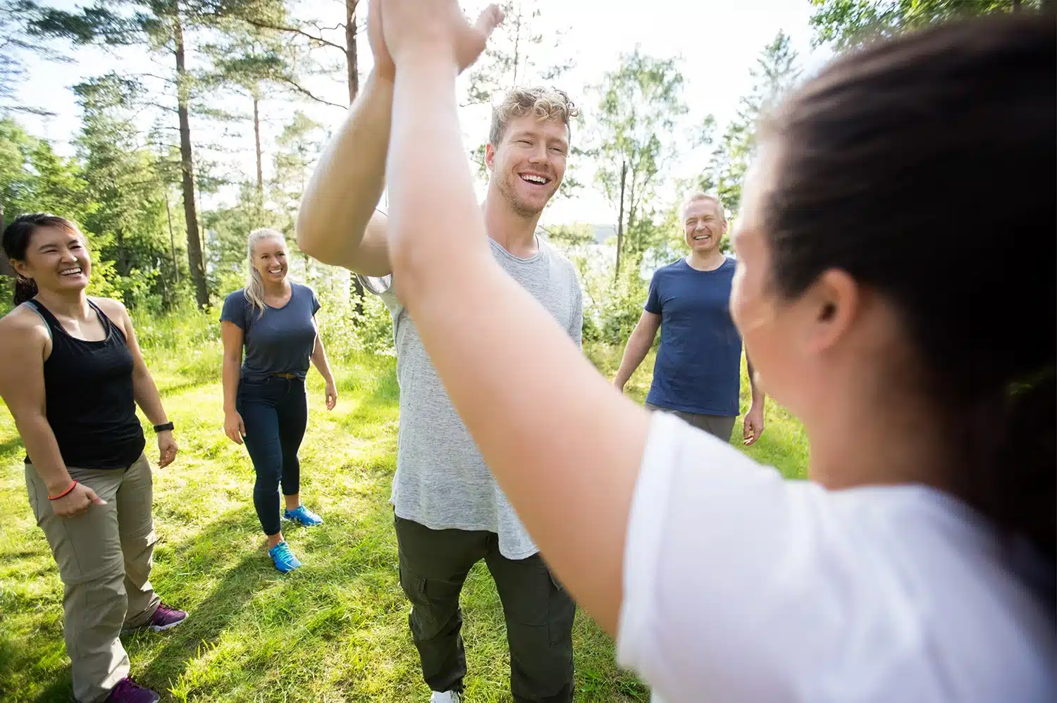 Coworkers participating in team bonding activities, high-fiving each other.